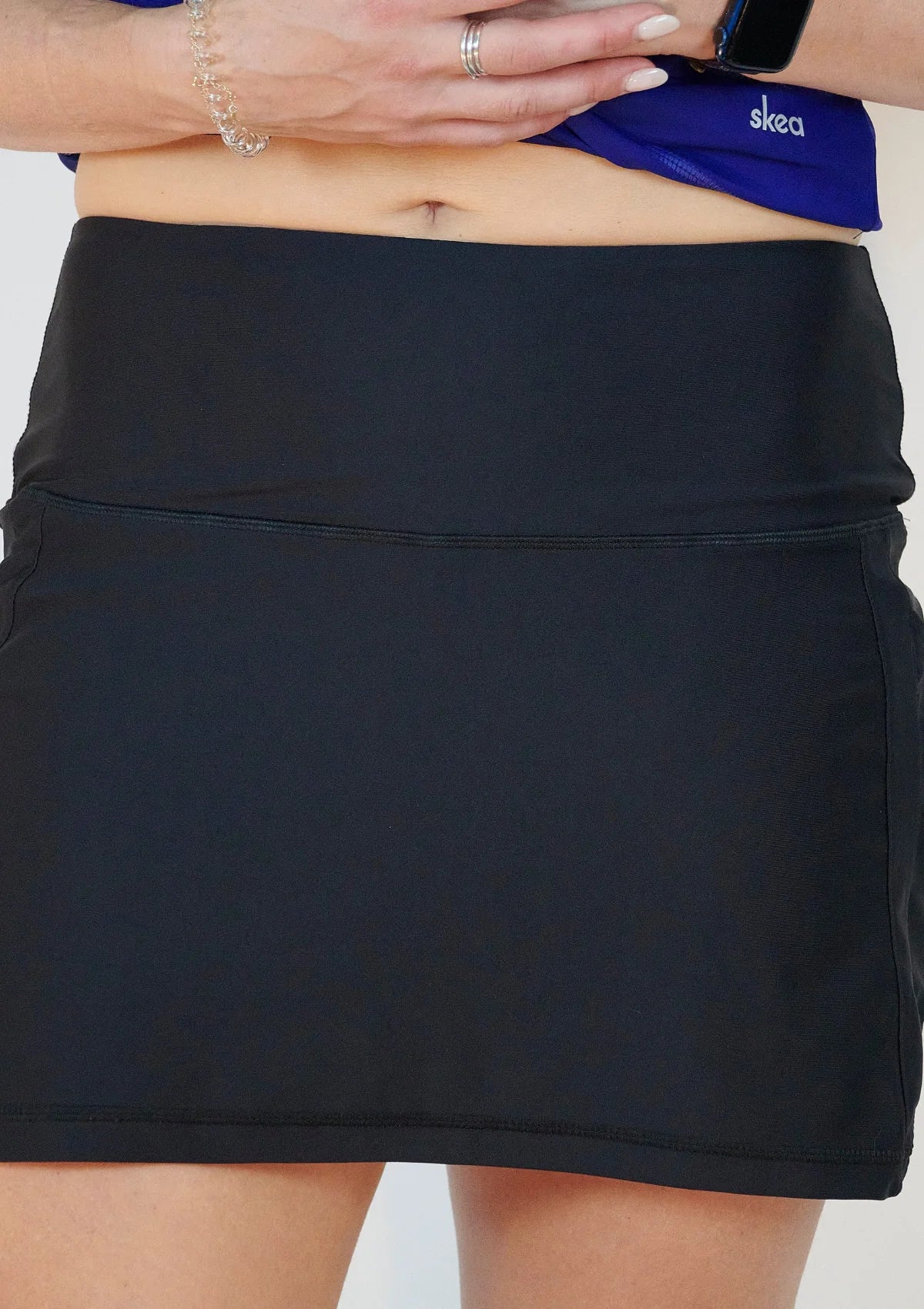 HIghwaisted Skea skort raised to show woman's bellybutton