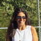 Woman wearing Revo Rimless Descend sunglasses on pickleball court