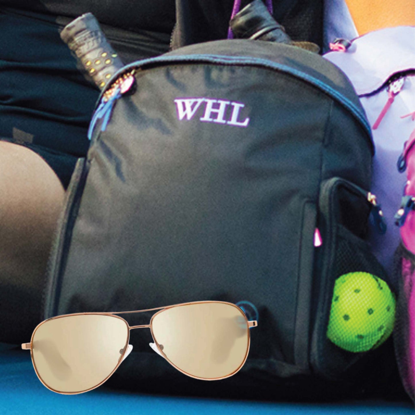 Black sport backpack with gold aviator sunglasses and pickleball