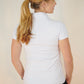 Back view of women in designer white shortsleeve Skea activewear top