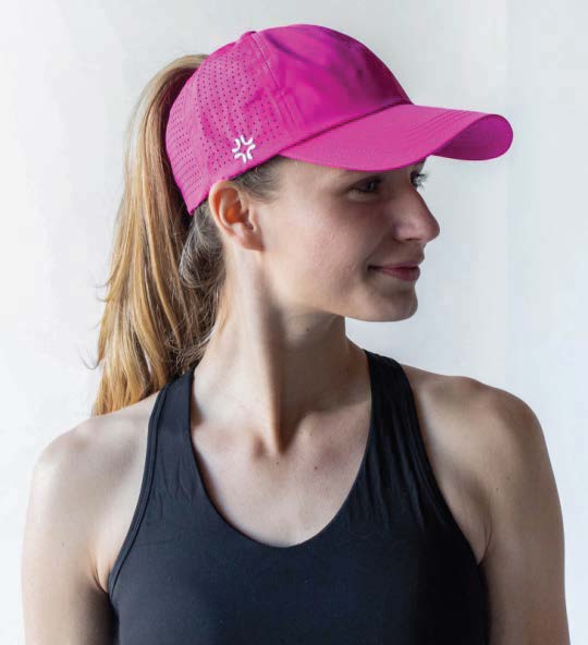 Woman wearing pink baseball cap by VIMHUE, front view with ponytail through hole in top of cap