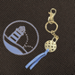 Goldtone pickleball keyring with blue suede tassel