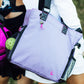 Backview of woman carrying women’s designer pickleball Tote with water bottle and ball in mesh pockets 